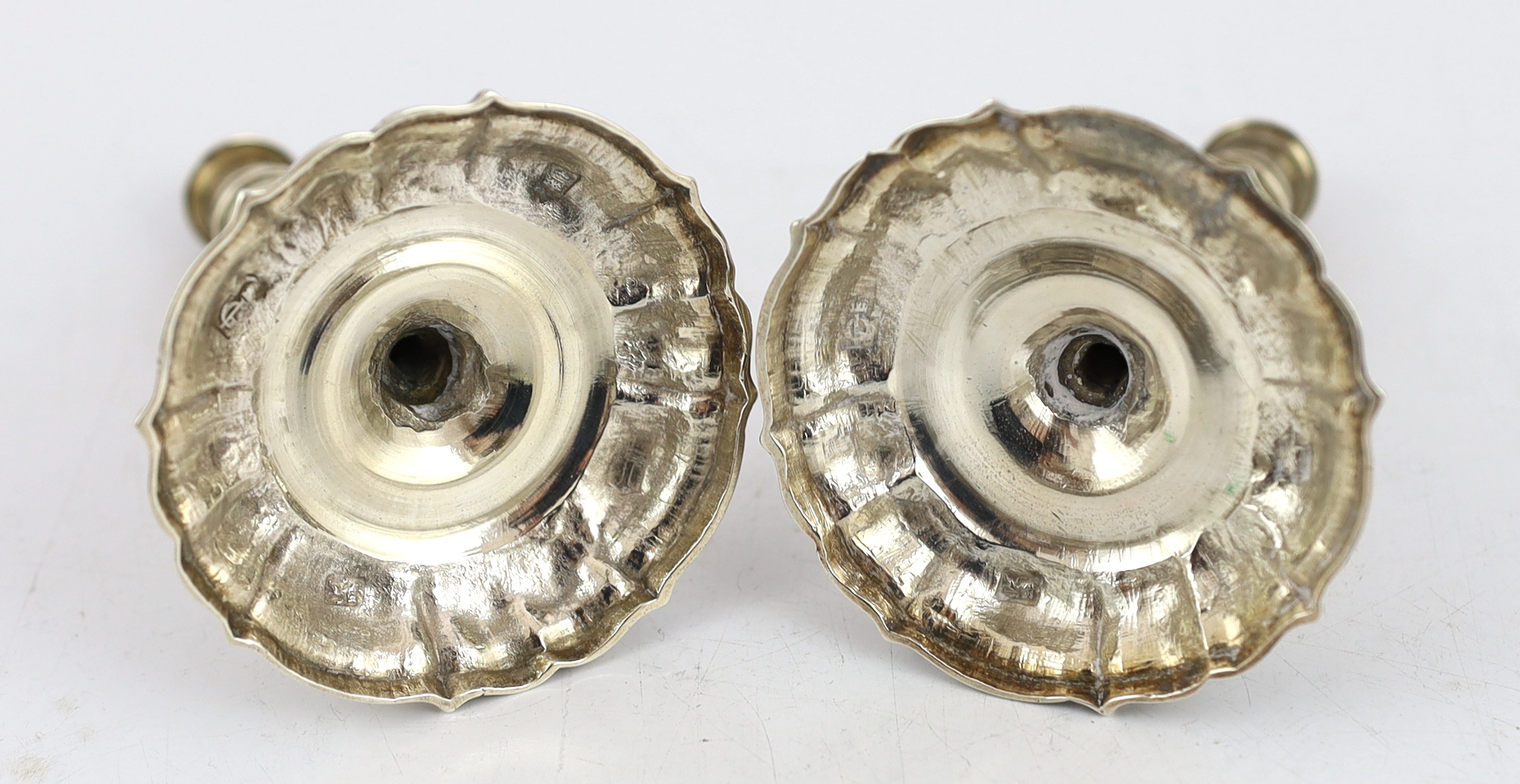 A pair of George II cast silver tapersticks, by James Gould